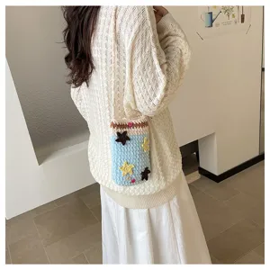 Knitted crossbody phone bag with cute star details, ideal for daily commuting and travel use.