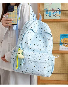 Japanese style sweet blue star print student backpack with cute plush pendant for daily school use.