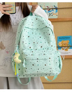 Cute mint green star print backpack for students, large capacity lightweight school bag.