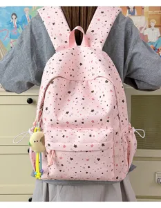 Cute pink star print student backpack, lightweight large capacity casual school bag for daily use.
