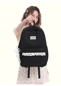 Schicker schwarzer Pünktchen Schulrucksack mit süßer Spitzenborte für Schülerinnen.