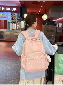 Sac à dos rose à pois grande capacité, idéal pour les trajets quotidiens, l'école et les voyages.