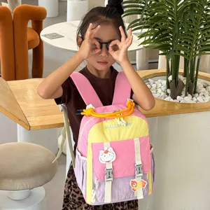 Detailed view of the colorful kids backpack with cute cartoon patches and front pocket design.