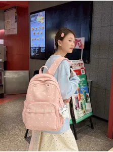 Détail de sac à dos d'école à pois roses mignon, grand sac de voyage décontracté pour ados