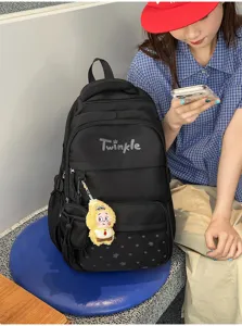 Stylish black star print student backpack with multiple compartments and cute plush pendant.