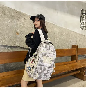Detailed view of this fashionable camouflage canvas backpack, showcasing multiple compartments.
