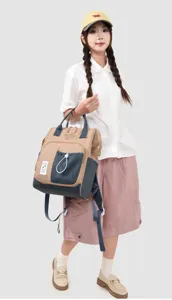 Casual colorblock backpack with large capacity, top frame opening, and front pocket detail.