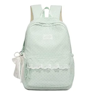 Grüner Polka-Dot-Schulrucksack mit weißer Spitzenborte und Schleifenanhänger für Mädchen.