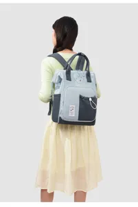 Detail view of a minimalist color-blocking casual backpack with large capacity for travel.