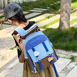 Close-up detail of the cute color-blocked children backpack worn outdoors by a kid.