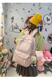 Joli sac à dos rose à motif d'étoiles avec de multiples poches pour collégiens.