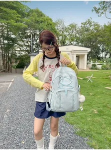 Japanese minimalist large capacity school backpack for students with cute plush pendant.