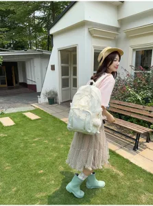 Japanese minimalist large capacity school backpack for students with cute fluffy charm.