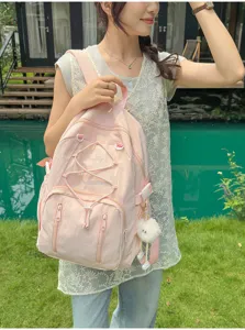 Detail view of the pink casual backpack, featuring front drawstring design and cute fuzzy charm.