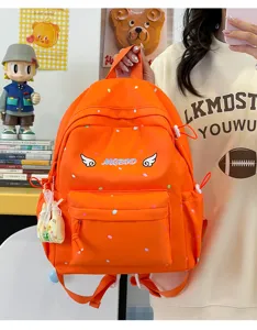 Süßer oranger Polka Dot Schulrucksack für Schüler im Alltag mit schönem Flügel-Stickdesign.