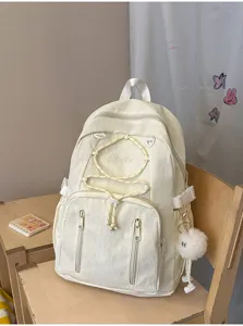 Minimalist cream white school backpack with drawstring and plush pendant, large capacity.