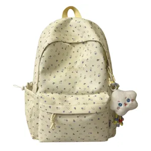 Detailansicht des Blumen-Rucksacks aus Stoff mit Plüsch-Anhänger, praktische Seitentaschen.