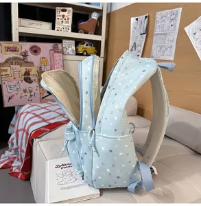 Joli sac à dos scolaire bleu avec motif d'étoiles, compartiments et grande capacité.