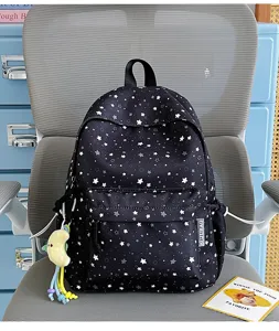 Star print school backpack detail view showing cute pattern and spacious front pocket.