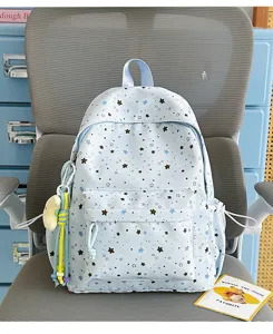Cute light blue star print school backpack detail view showing front pocket and cute design.