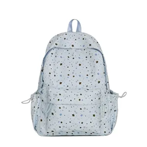 Detailed view of the cute star print and front pocket on the light blue rucksack.