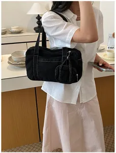 Black canvas shoulder bag with contrast stitching and mini pouch for daily women.