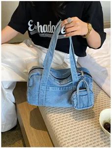 Casual vintage washed denim tote bag detail, stylish single shoulder commuter handbag.