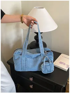Detail shot of retro washed denim shoulder bag with mini coin purse accessory, casual daily style.