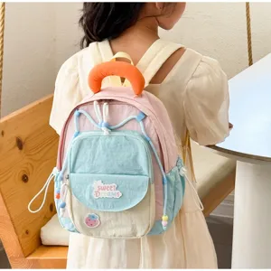 Colorful cute kindergarten school backpack for little girls with pastel color block design.