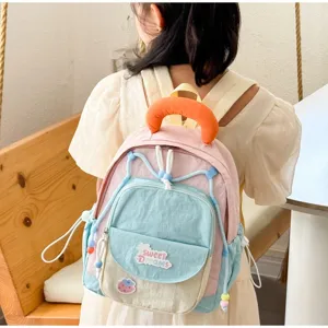 Cute colorful kids backpack detail showing sweet dreams embroidery and beaded handle.