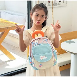 Cute colorful kids backpack detail view, sweet dreams patch design, pink and blue tone.
