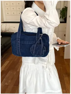 Vintage washed denim shoulder bag detail, casual daily tote with mini coin purse accessory.