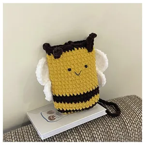 Cute handmade crochet bee phone bag detail showing textured knit design and soft fabric wings.