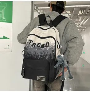 Detailed shot of gradient student backpack with letter print, showing back view in urban hallway.