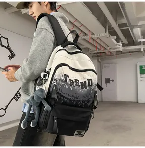 Detailed view of stylish gradient school backpack with letter print and cute plush pendant.