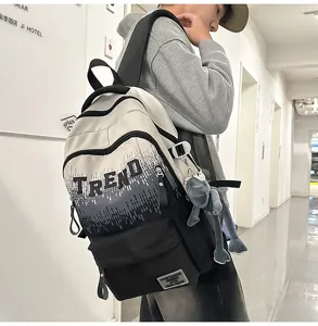 Stylish gradient college backpack with letter print and cute plush pendant for students.