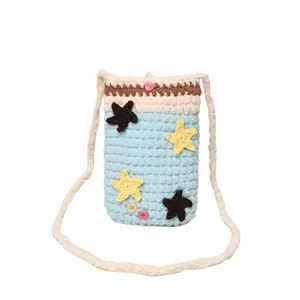 Handmade knitted crochet phone bag detail, cute star decoration, cross-body shoulder strap.