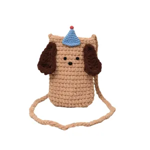 Handmade crochet dog crossbody phone bag with cute blue party hat and brown floppy ears.