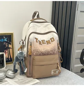 Gradient beige school backpack for teenage girls, large capacity casual daypack with cute frog pendant.
