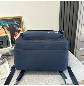 Detail view of large capacity student backpack, solid navy blue daily school bag with straps.