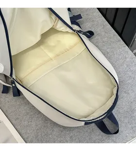 Interior detail view of the large capacity student school backpack in white and navy blue.