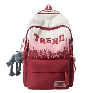 Detailed view of the gradient school backpack featuring trendy letter print and a cute doll pendant.
