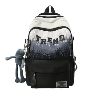 Close-up detail of the gradient school backpack with trendy letter design and plush charm.