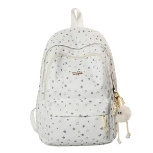 Sac à dos mignon avec motif d'étoiles, multiples compartiments et pendentif duveteux pour l'école.
