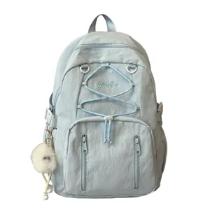 Light blue casual backpack with bungee cords and cute plush charm, spacious daily school bag.