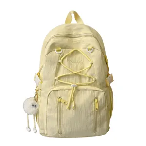 Japanese style minimalist light yellow large capacity casual backpack with cute doll pendant.