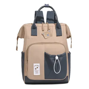 Detail view of the stylish contrast color diaper backpack, featuring a cute bear patch design.