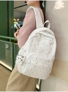 Sac à dos élégant à pois pour l'école et les trajets avec pendentif chat mignon blanc.