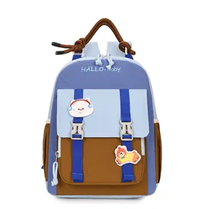Detailed view of the cute kids color block backpack with cartoon patches and double buckles.