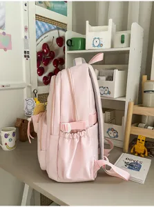 Pink student backpack side detail showing multiple compartments, side pockets and adjustable straps.